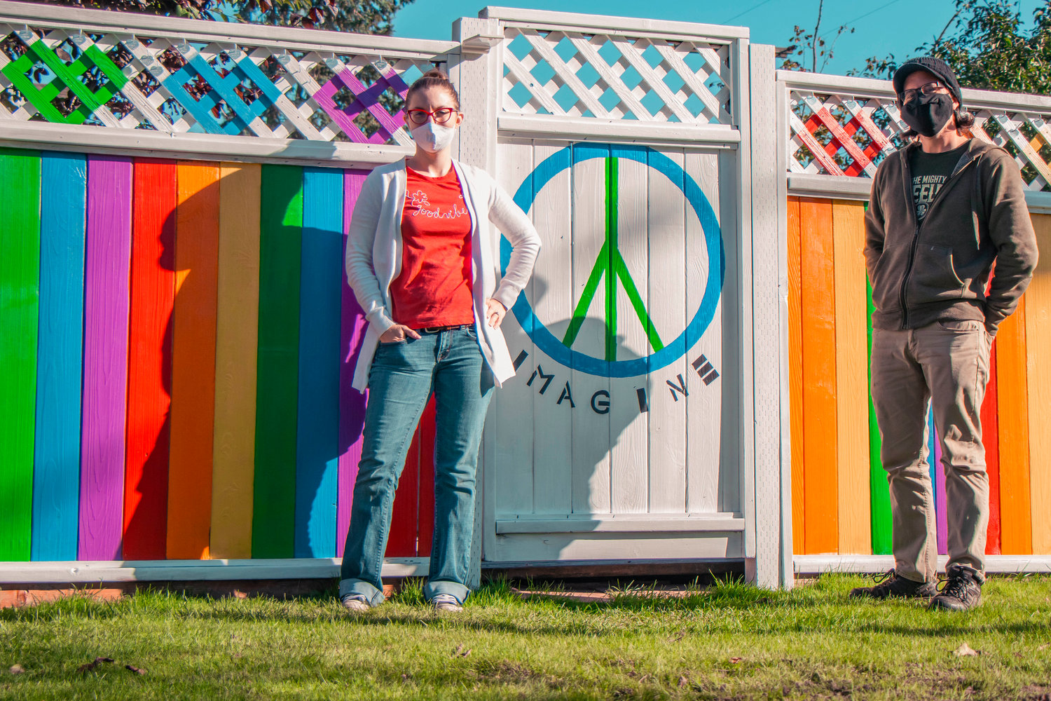 Jacky Vance and Kyle Wheeler pose for a photo in front of a rainbow painted fence in Chehalis on Monday.