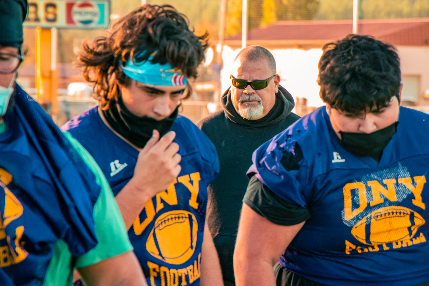 Coach Wayne Nelson looks on while players adjusts facemasks during practice on Monday at Onalaska High School.