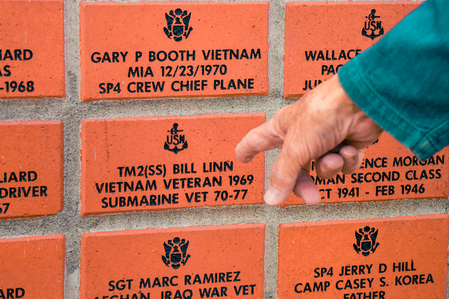 Bill Linn points out his brick in the Veterans Wall of Honor in Toledo on Thursday.