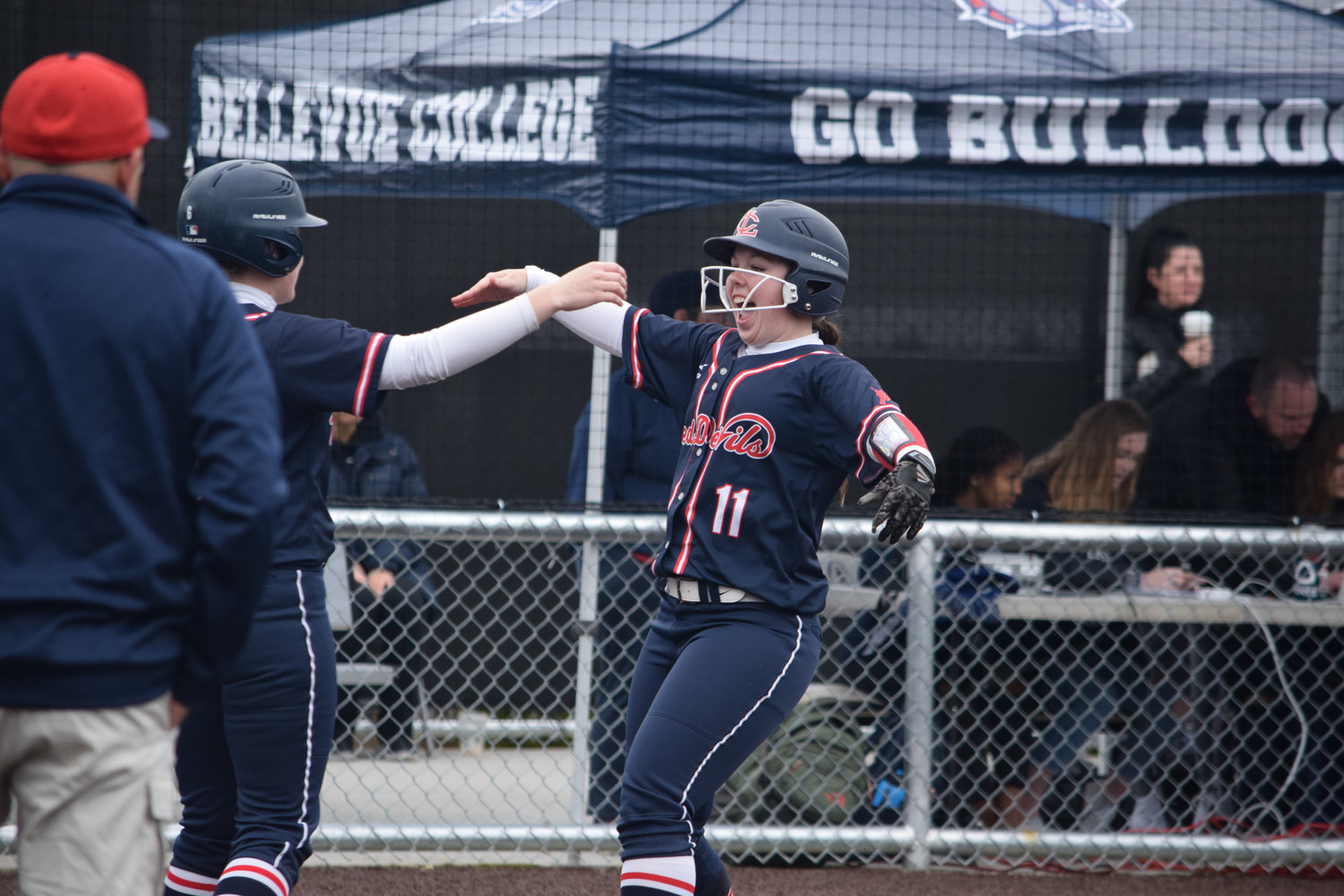 Napavine alumna Ada Williams (11) celebrates with a Lower Columbia teammate after hitting a home run in March.