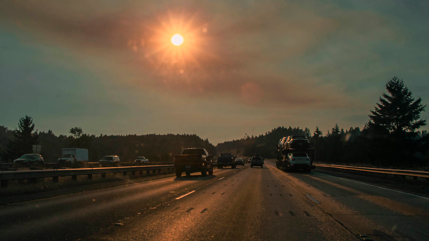The sun shines through wildfire smoke onto Interstate 5 on Tuesday.