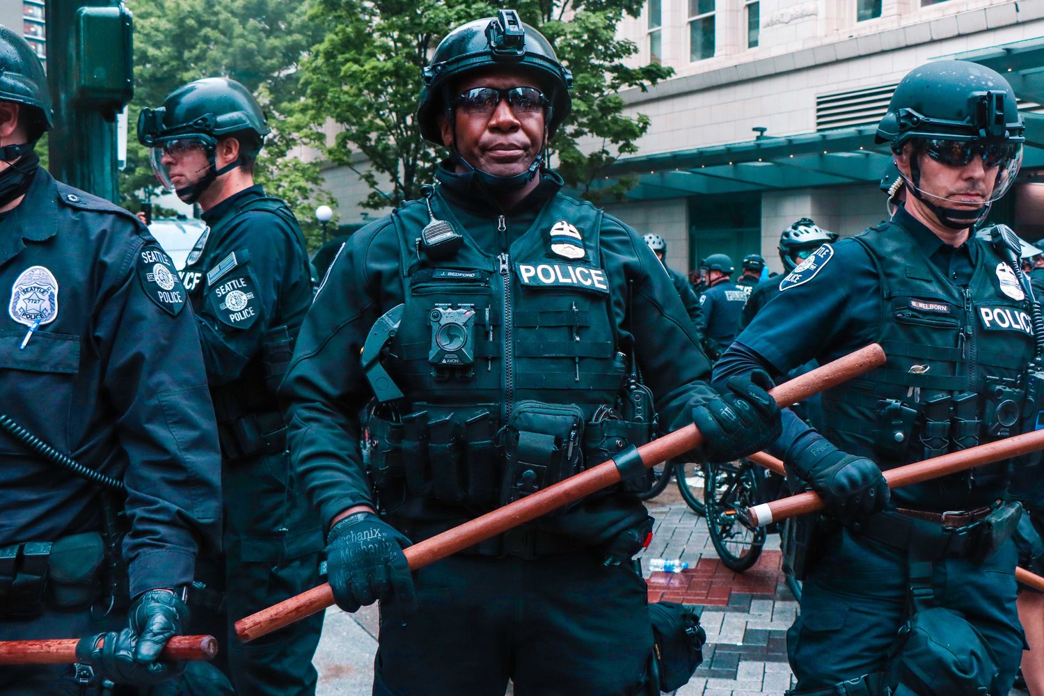 Seattle Police Department officers stand guard during protests in late May.