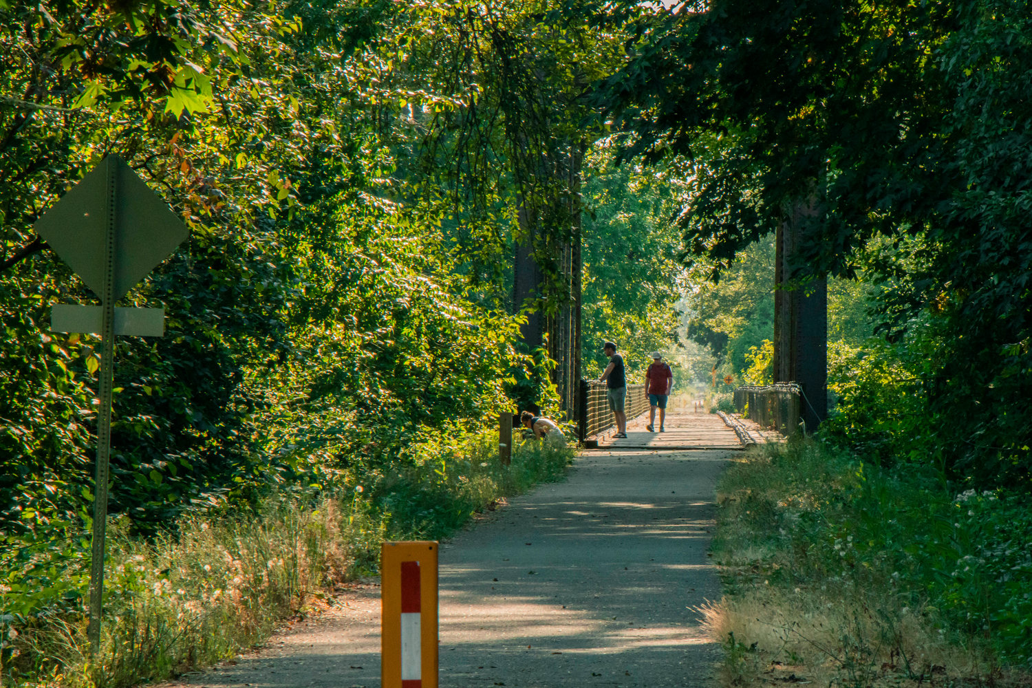 Visitors walk along a bridge on the Willapa Hills Trail Thursday afternoon in Chehalis.
