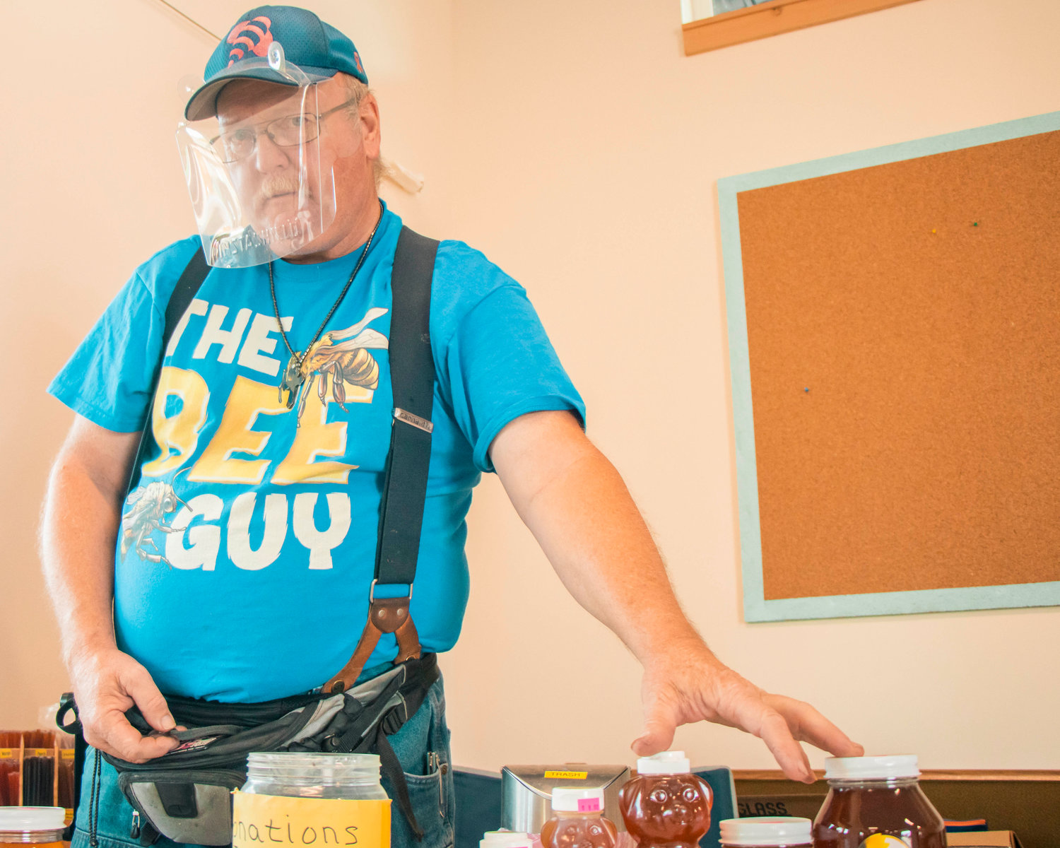 Owner Rob Jenkins, of Bee Wrangler Honey, sports a face mask and his ‘The Bee Guy’ shirt at the Toledo Thursday Market.