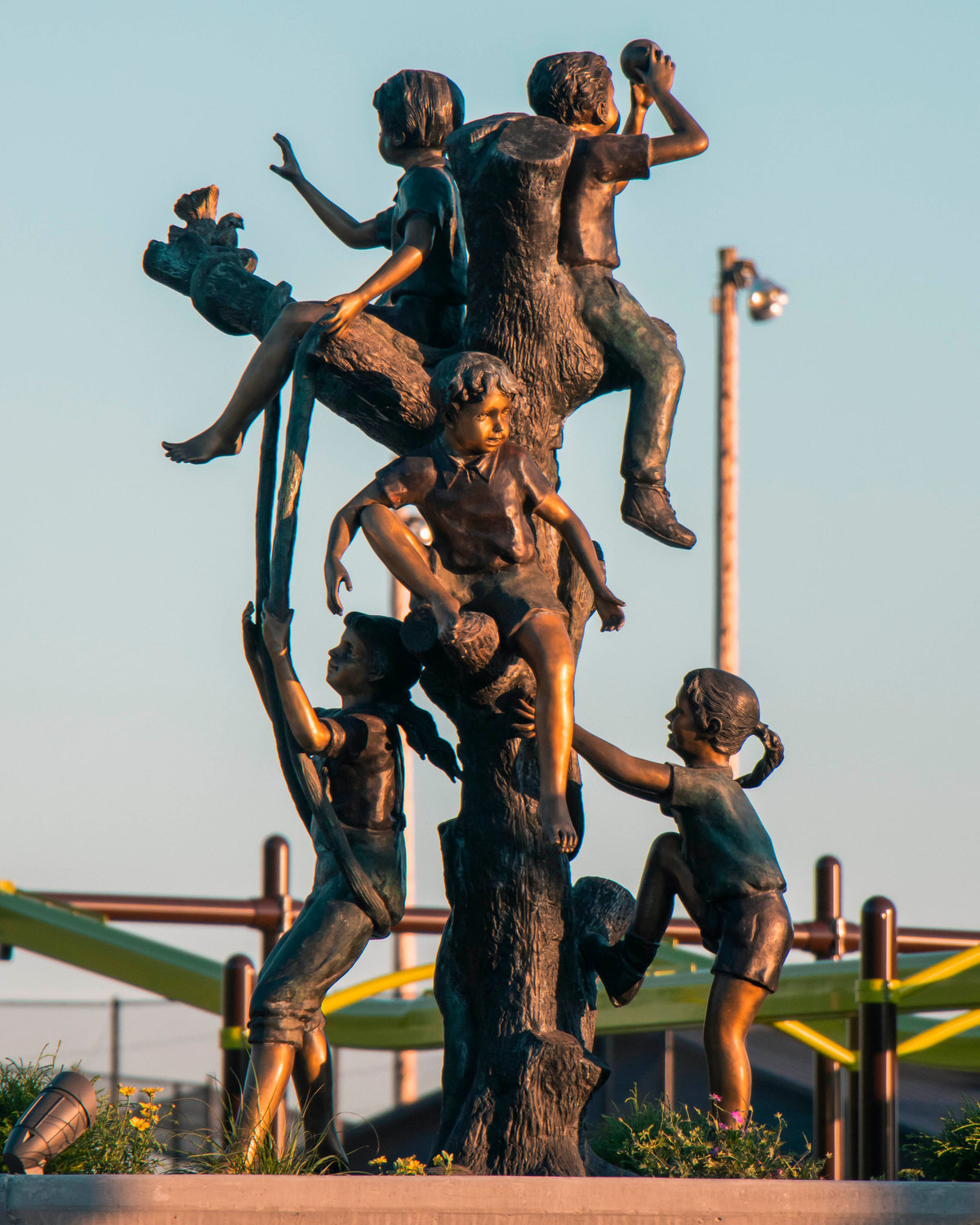 A statue at the center of Penny Playground gleams in the sun Tuesday evening in Chehalis.