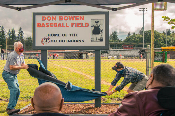 The Don Bowen Baseball Field sign is unveiled in front of dozens of spectators Thursday at Toledo High School.