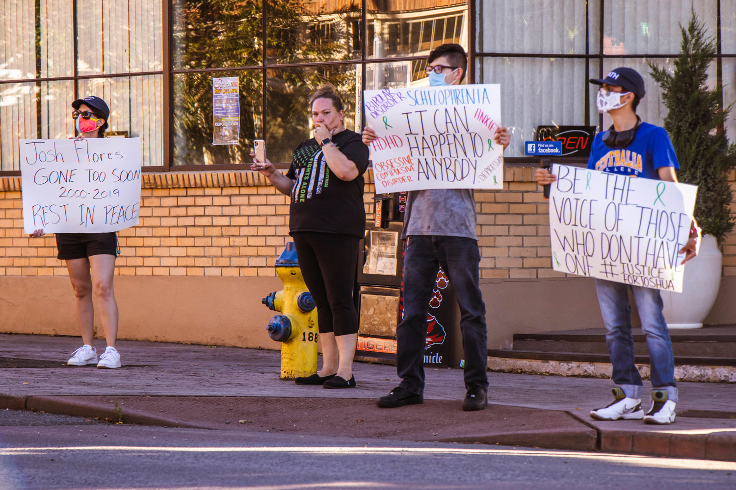 Demonstrators gather outside the Centralia Police Station Monday afternoon to honor the life of Joshua Flores who died on June 18, 2019 at the age of 18.
