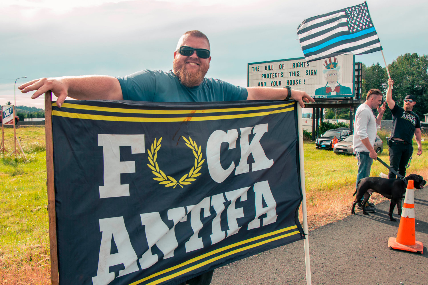 Scott, from Clark County, holds a sign in opposition of ‘Antifa’ in front of the Hamilton sign Tuesday afternoon in Napavine.