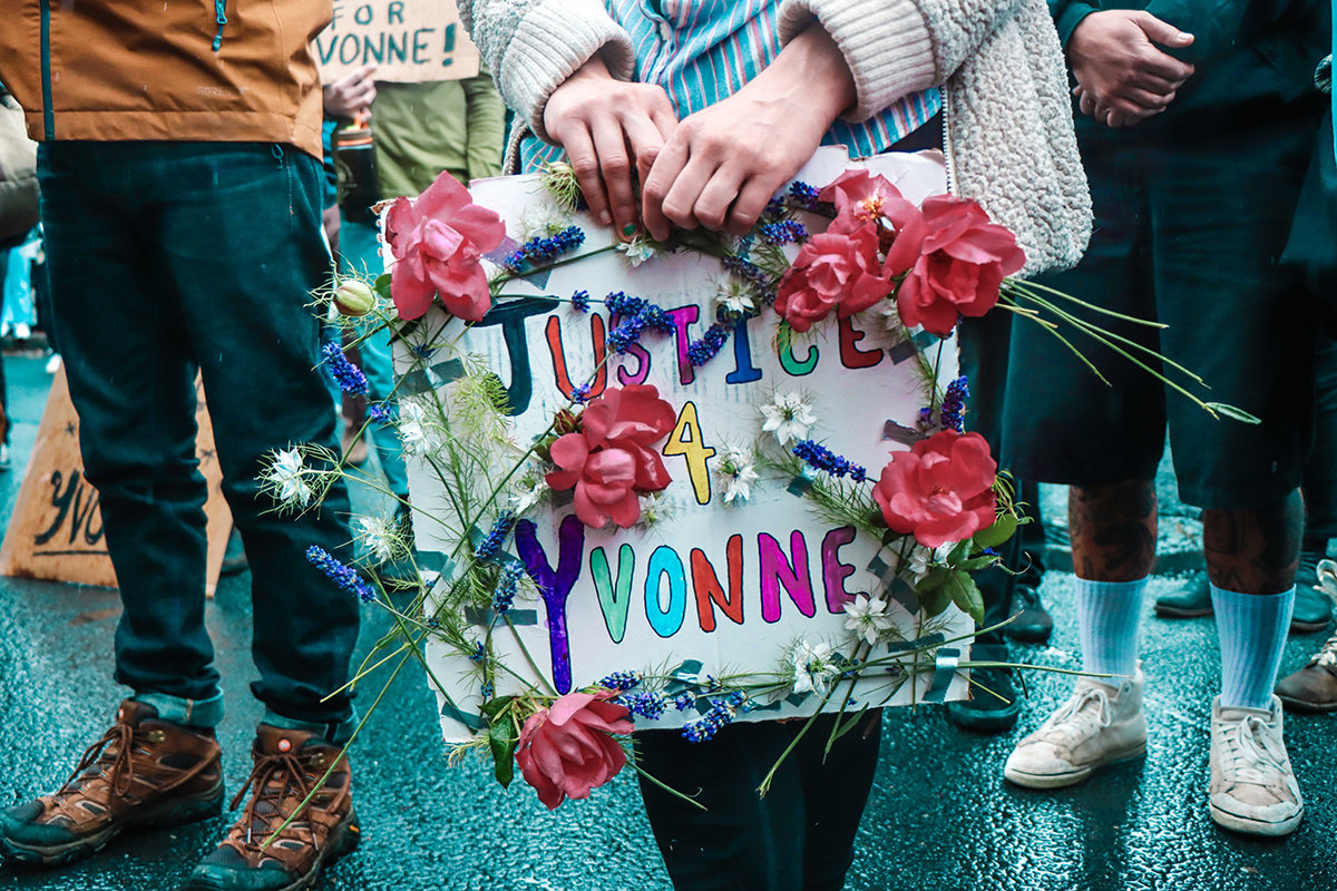 A 'Justice for Yvonne' sign is framed by flowers during a demonstration at the Lewis County Courthouse Friday morning in Chehalis.