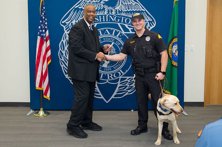 Chief John Batiste of the Washington State Patrol and trooper Justin Schaffer with Frankie the K9. 
