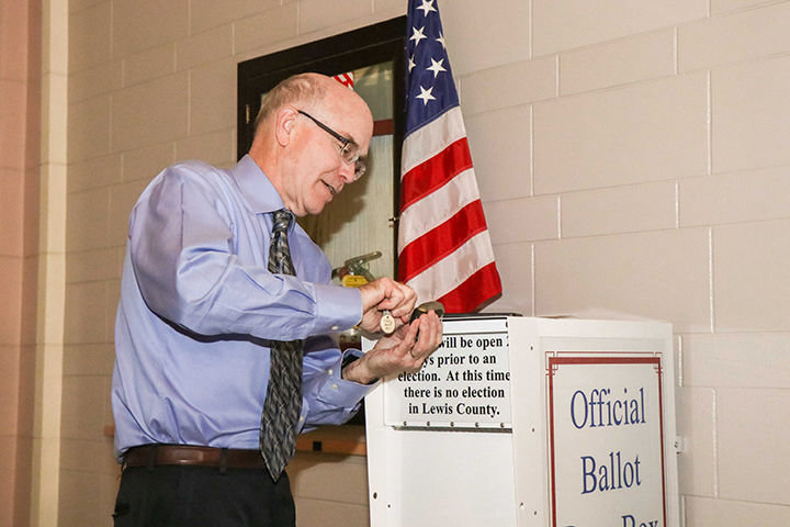 Lewis County Auditor Larry Grove locks the ballot box as ballots prepare to be counted Tuesday night at the Lewis County Historical Courthouse in Chehalis.