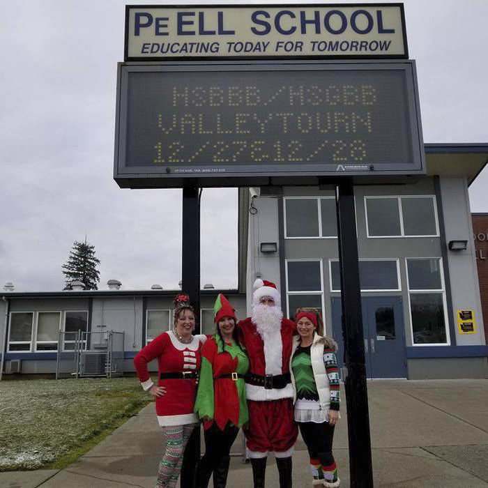 Peter Abbarno, Santa Claus, with Elves Holly Abbarno, Kim Witham and Heather Stewart delivering presents for the Forgotten Children’s Fund to families in Pe Ell.
