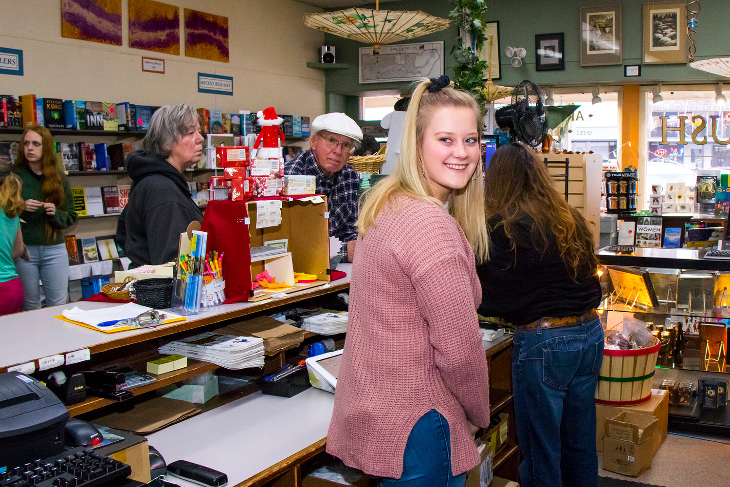 Abby Jennings looks back and smiles while helping inside Book 'N' Brush Friday afternoon in Chehalis.
