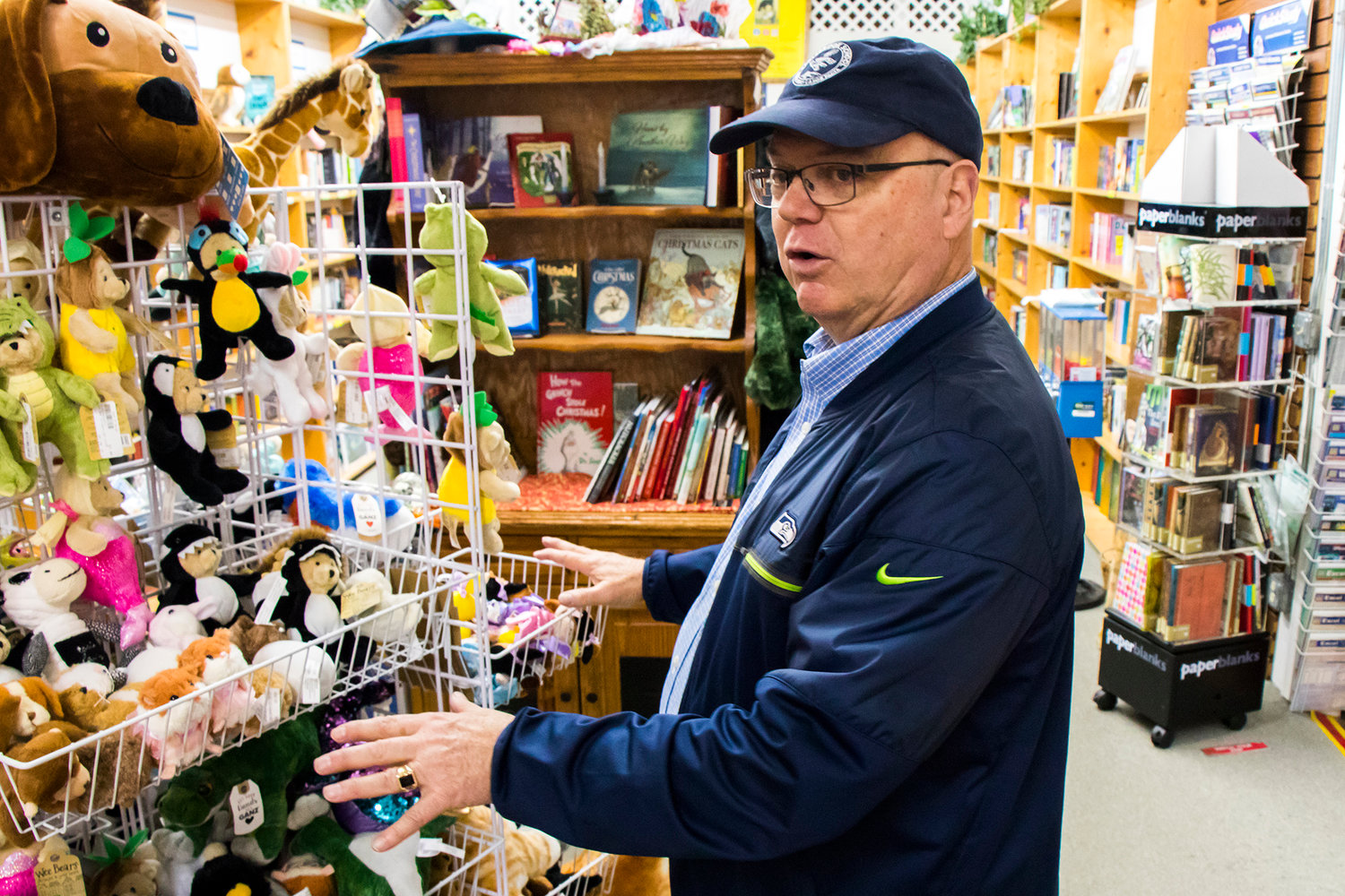 Owner David Hartz talks about toys on display inside Book 'N' Brush Friday afternoon in Chehalis.