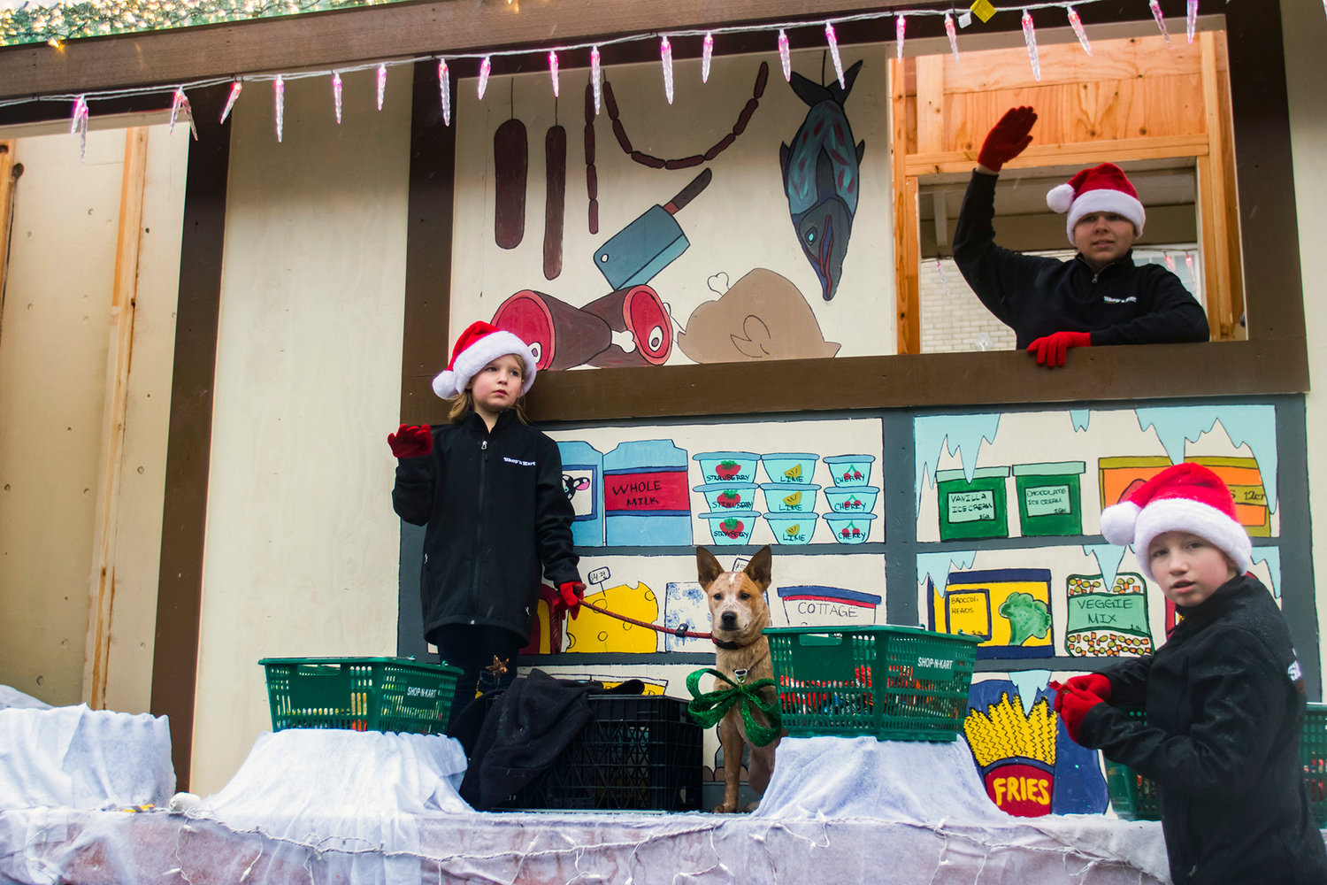 Kids stand in and around the Shop-N-Kart float during the annual Santa Parade Saturday morning in downtown Chehalis.