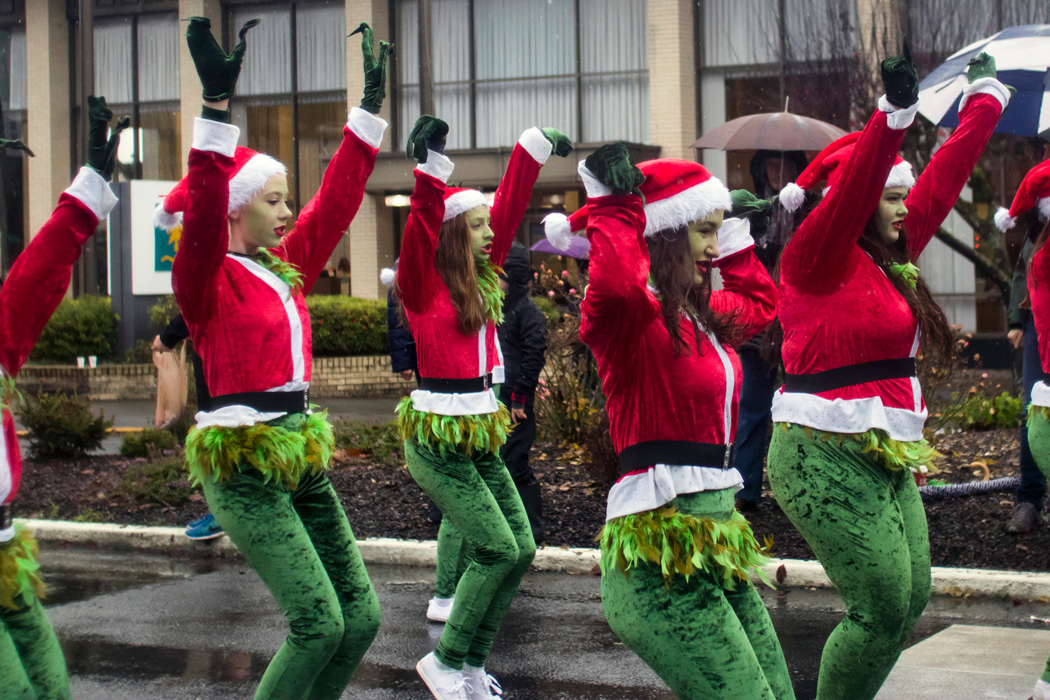 Girls dressed as the grinch dance along to music during the annual Santa Parade Saturday morning in downtown Chehalis.