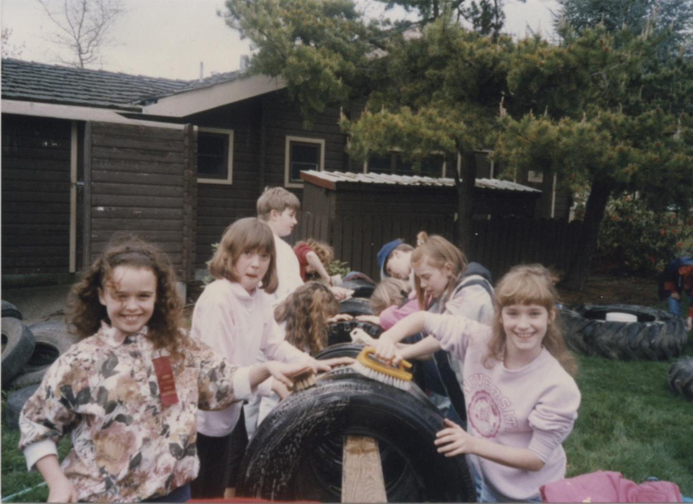 Kids help scrub tires clean during the original construction of Penny Playground.