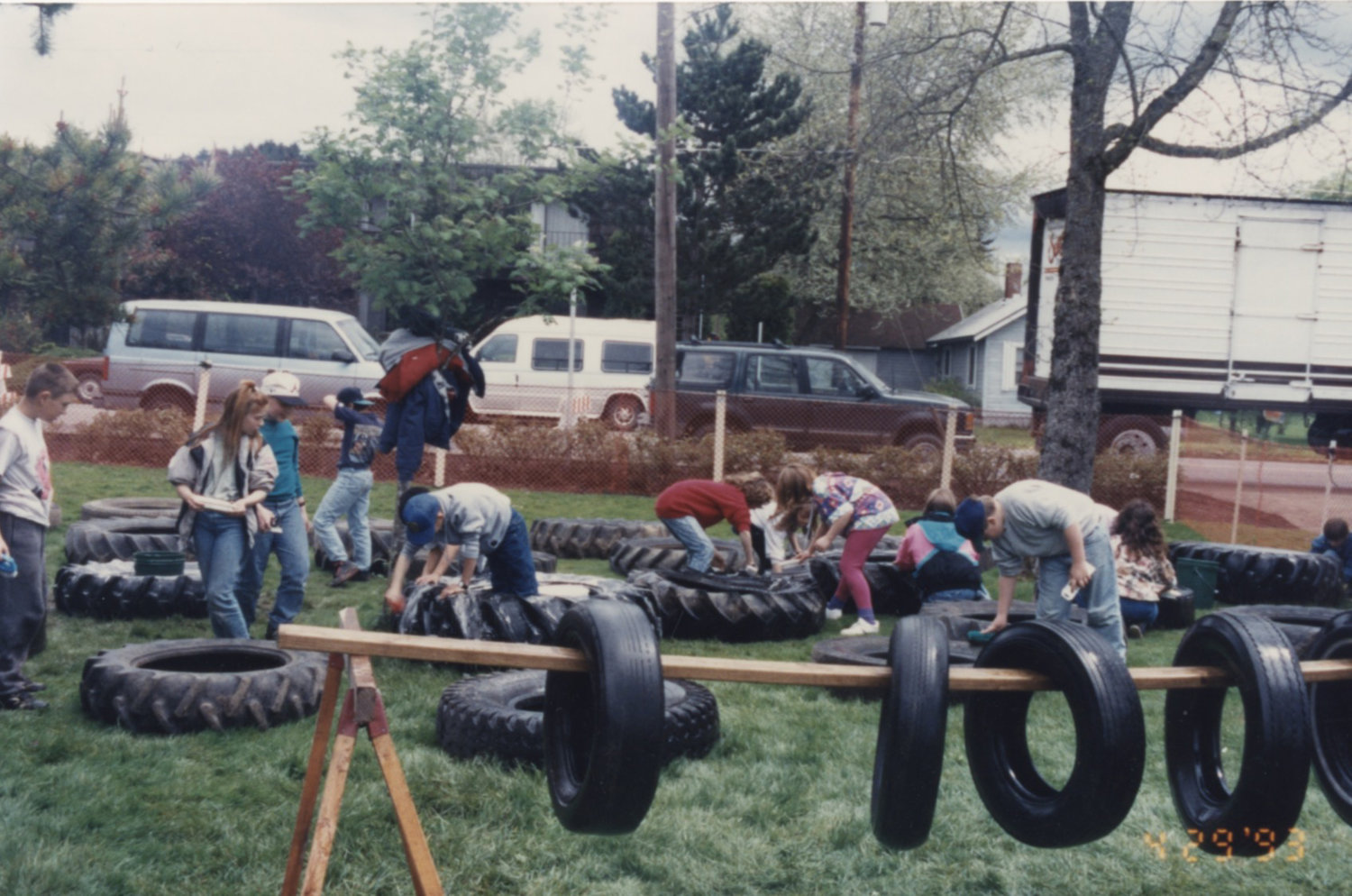 Kids help scrub tires clean during the original construction of Penny Playground.