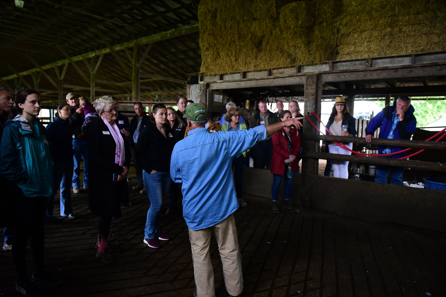 Ross McMahan, owner of the Cowlitz Meadows Dairy, talks to regional leaders about his operation and the challenges he faces during the Lewis County Farm Bureau Tour of Ag Wednesday afternoon.