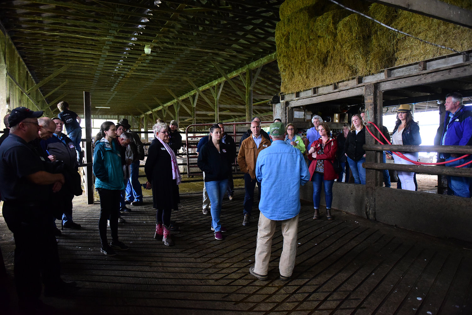 Ross McMahan, owner of the Cowlitz Meadows Dairy, talks to regional leaders about his operation and the challenges he faces during the Lewis County Farm Bureau Tour of Ag Wednesday afternoon.