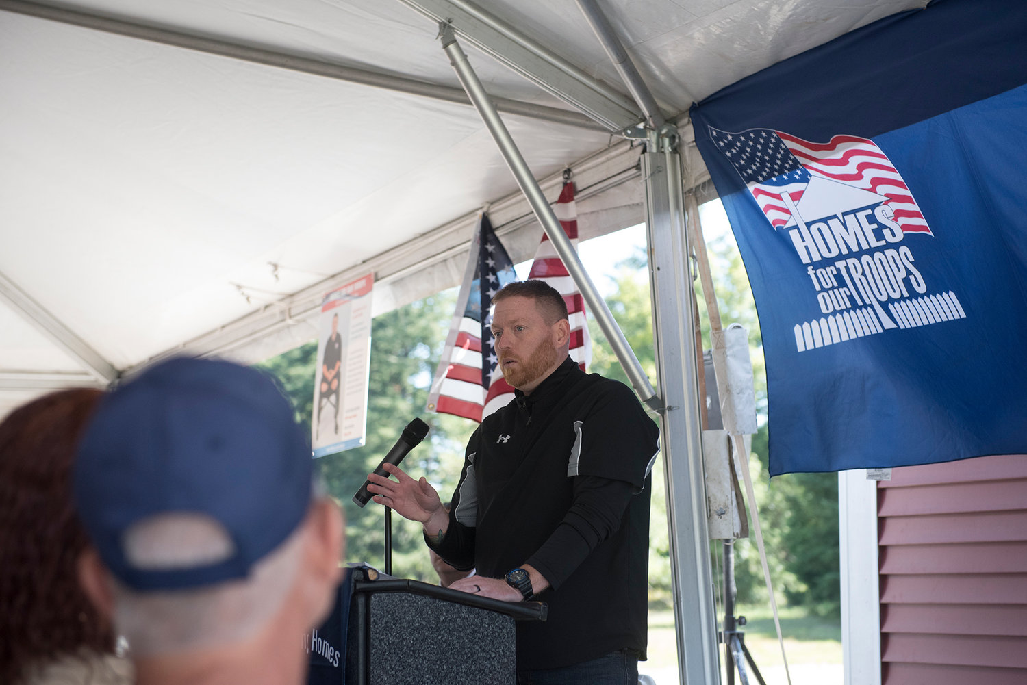 Chad Green, best friend of U.S. Army Sgt. Jereme Sawyer, talks to a crowd at a ceremony in front of Sawyer’s new home in Tenino on Saturday, July 20, 2019.
