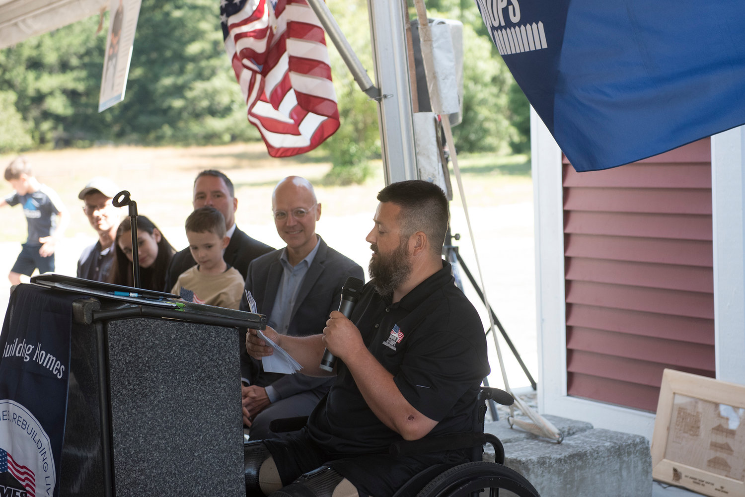 U.S. Army Sgt. Jereme Sawyer addresses a crowd in front of his new home in Tenino on Saturday, July 20, 2019.