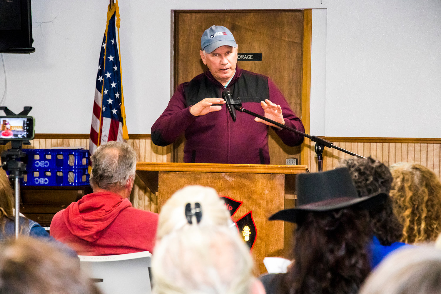 County commissioner Gary Stamper addresses a packed town hall in Randle about a proposed water bottling plant that has drawn strong opposition in the community.