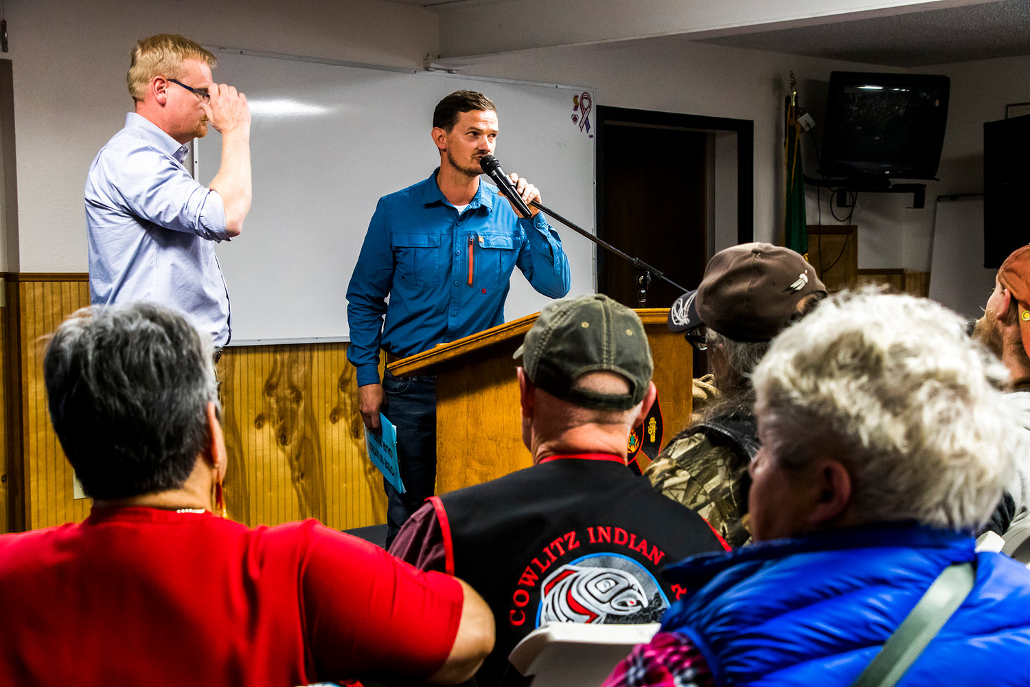Local resident Craig Jasmer, center, addresses a packed town hall in Randle about a proposed water bottling plant that has drawn strong opposition in the community.