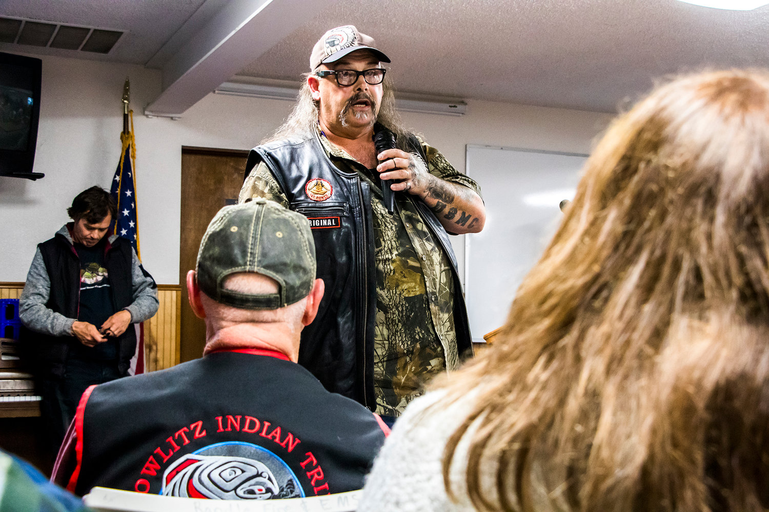 Greg LaDue-Grove, a member of the Cowlitz Tribe, addresses a packed town hall in Randle about a proposed water bottling plant that has drawn strong opposition in the community.