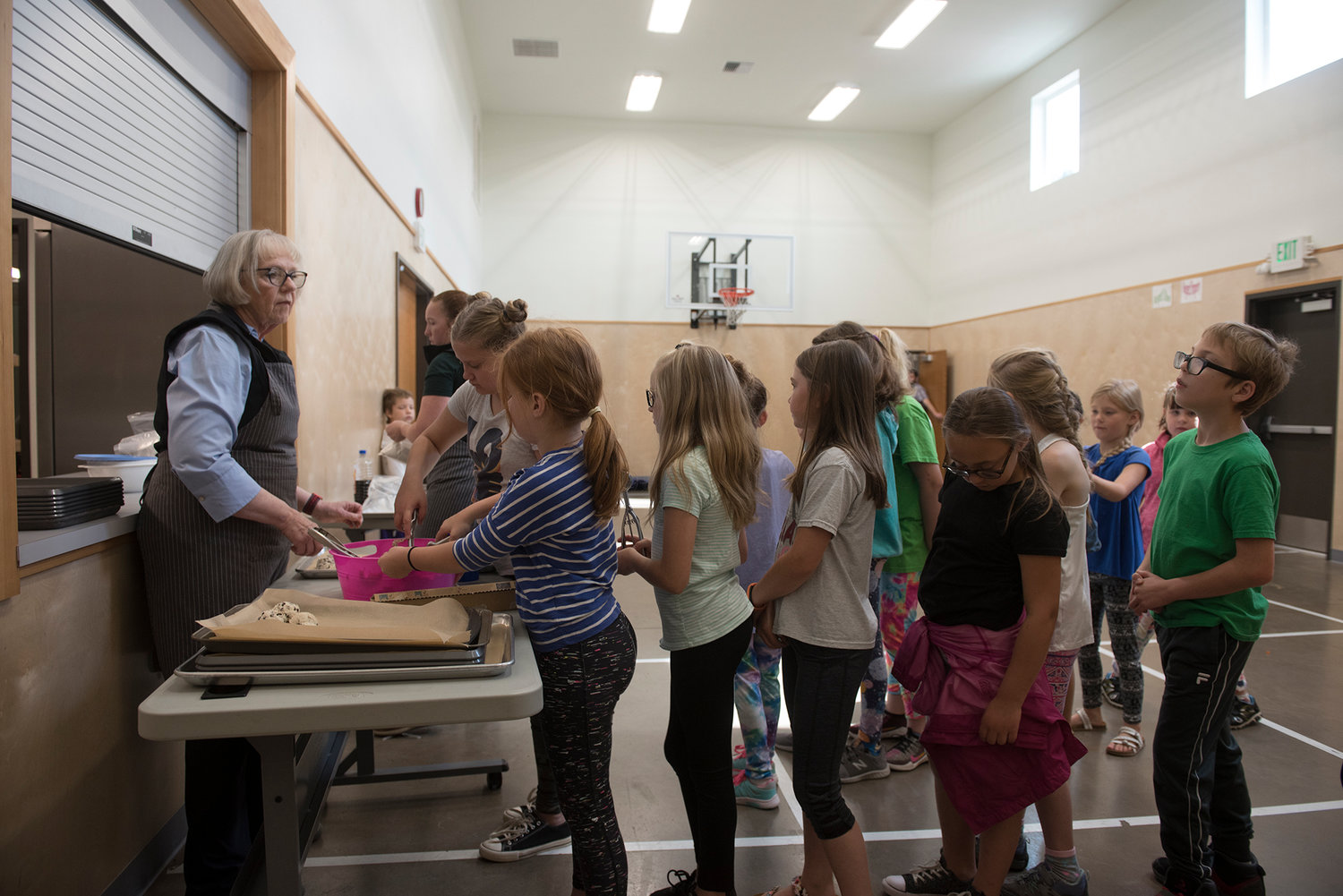 Kids line up to scoop cookie dough onto a baking sheet at the Boys &amp; Girls Club of Chehalis on Tuesday, June 25, 2019.