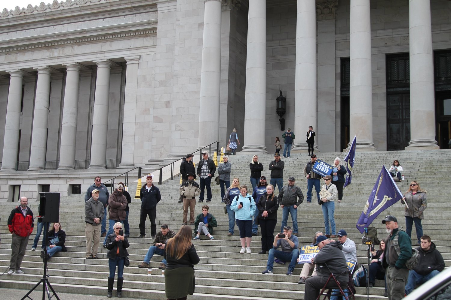 FILE PHOTO — Prior to members of the legislature arriving, attendees of the State of Liberty Rally last March gather on the steps of the legislative building. -- Photo by Emma Epperly, WNPA Olympia News Bureau