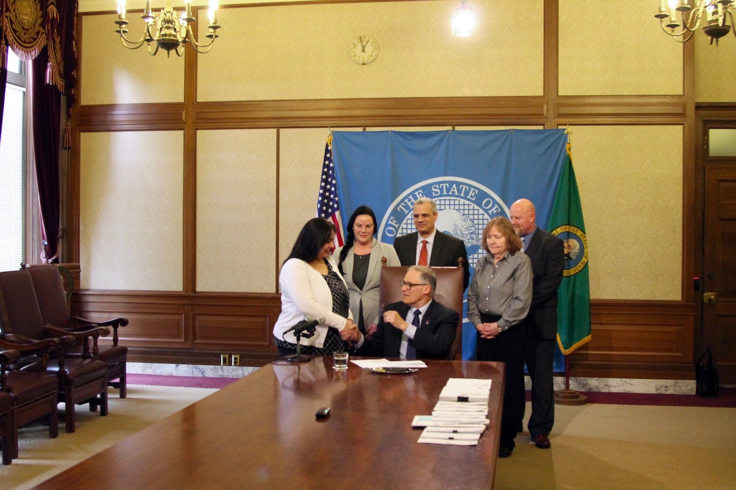 Gov. Jay Inslee signs Sen. Manka Dhingra’s bill April 17. The bill requires information to be provided to felons on their voting rights after being released from custody – Photo by Emma Epperly, WNPA Olympia News Bureau 