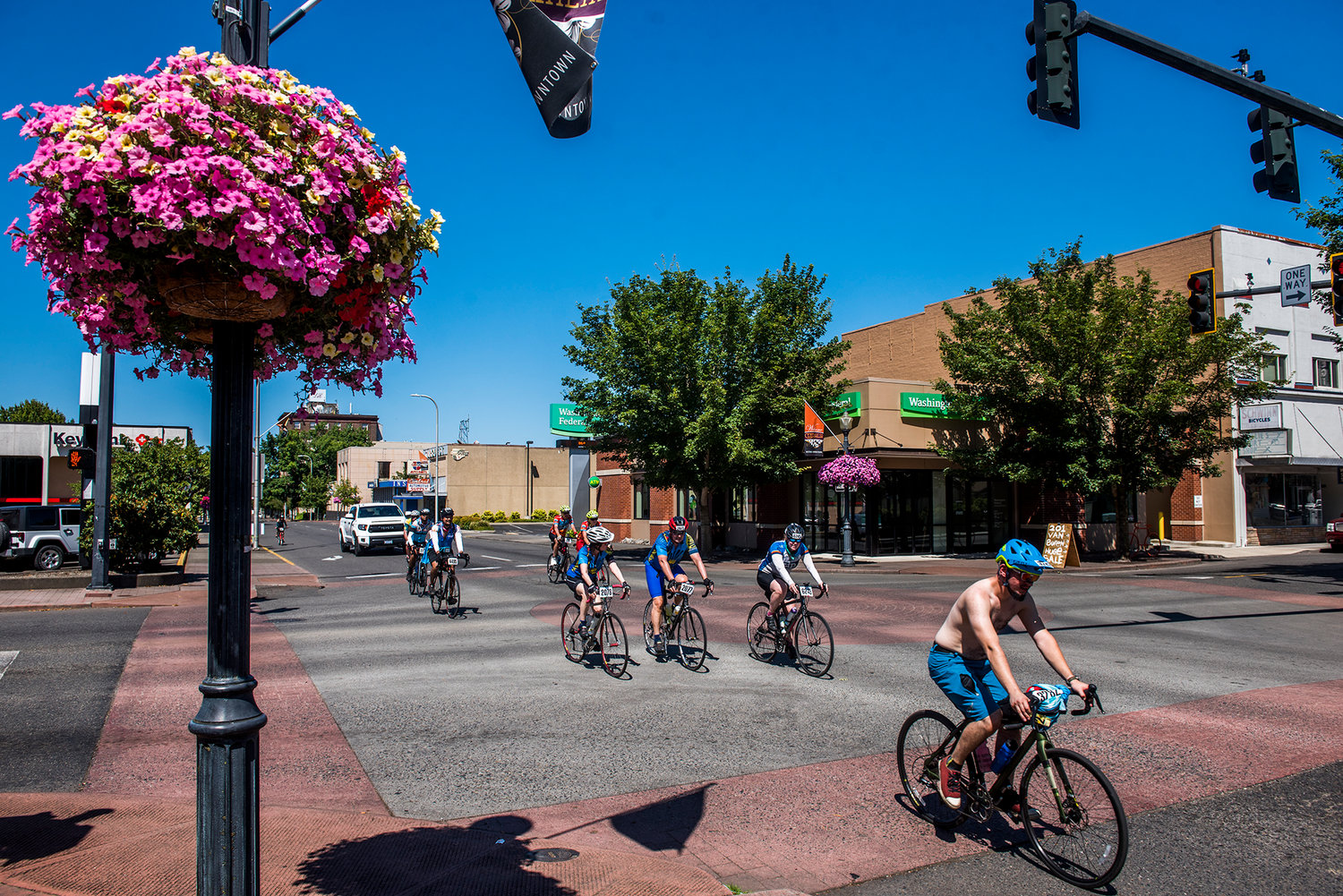 A shirtless man leads a pack of cyclists through downtown Centralia on Saturday afternoon during the annual Seattle to Portland bicycle event.