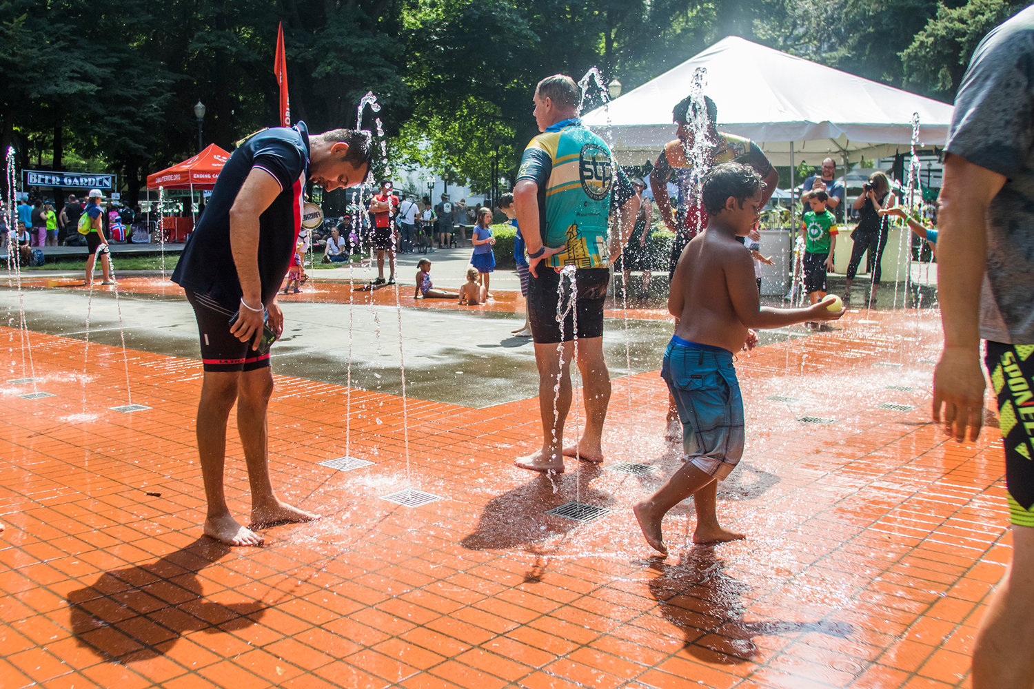 STP finishers rinse off in a nearby water park Sunday afternoon at Holladay Park in Portland, Oregon.
