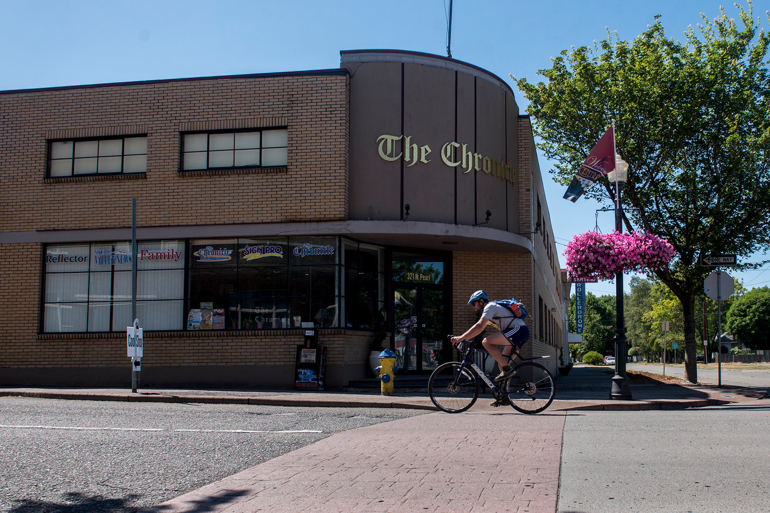 Chronicle reporter Alex Brown keeps a steady pace as he pedals past The Chronicle offices on Saturday afternoon during the STP.