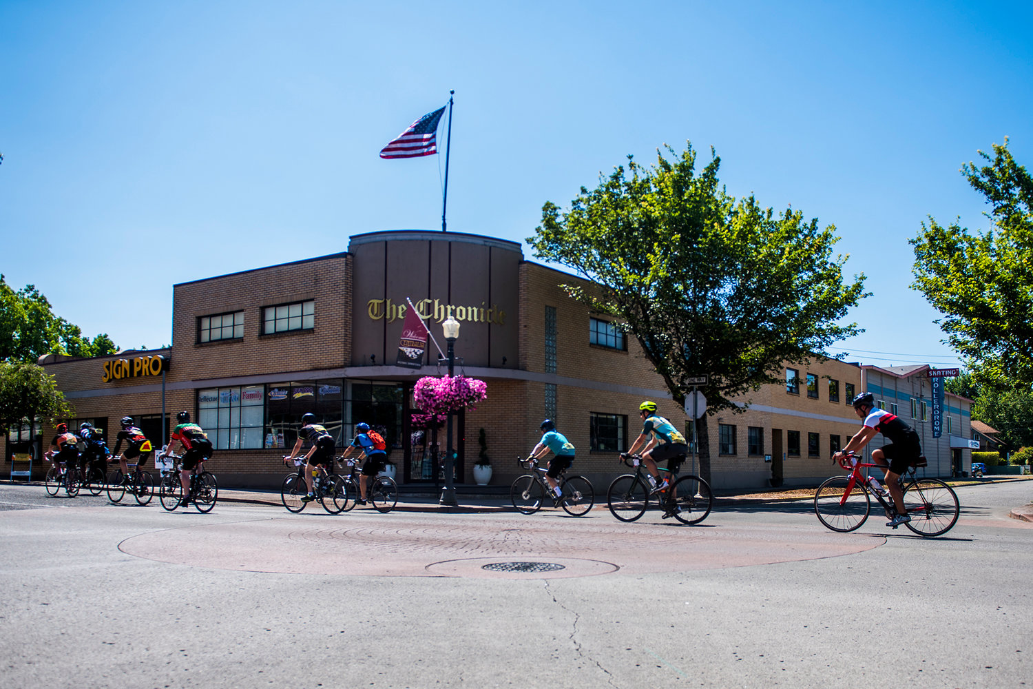 A group of cyclists pass the offices of The Chronicle on Saturday afternoon during the annual STP event.