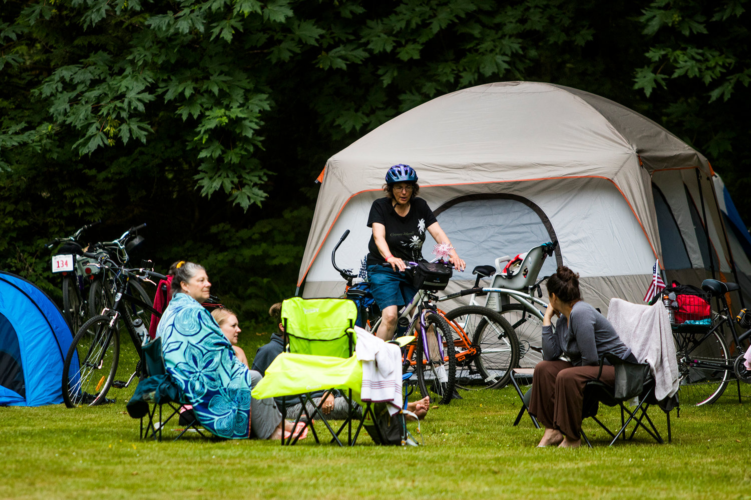 FILE PHOTO — Mary Huntting, of Tumwater, rides her bike into her campsite at Rainbow Falls State Park after the annual Ride The Willapa event.