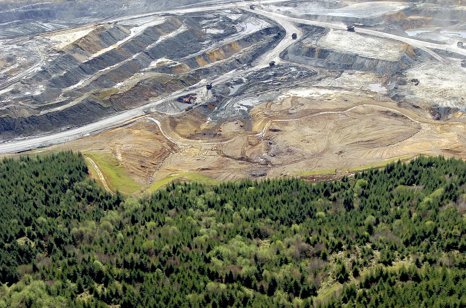 CHRONICLE FILE PHOTO — An active open pit coal mine at TransAlta is seen in this 2004 Chronicle file photo. The area has been replanted and returned to pasture in the years since the mine closed, and now TransAlta intends to turn the area into a massive solar energy project that when complete would be the largest in the state. 