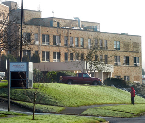 A man in a red coat stands in front of ABHS in Chehalis in this 2011 Chronicle file photo. 