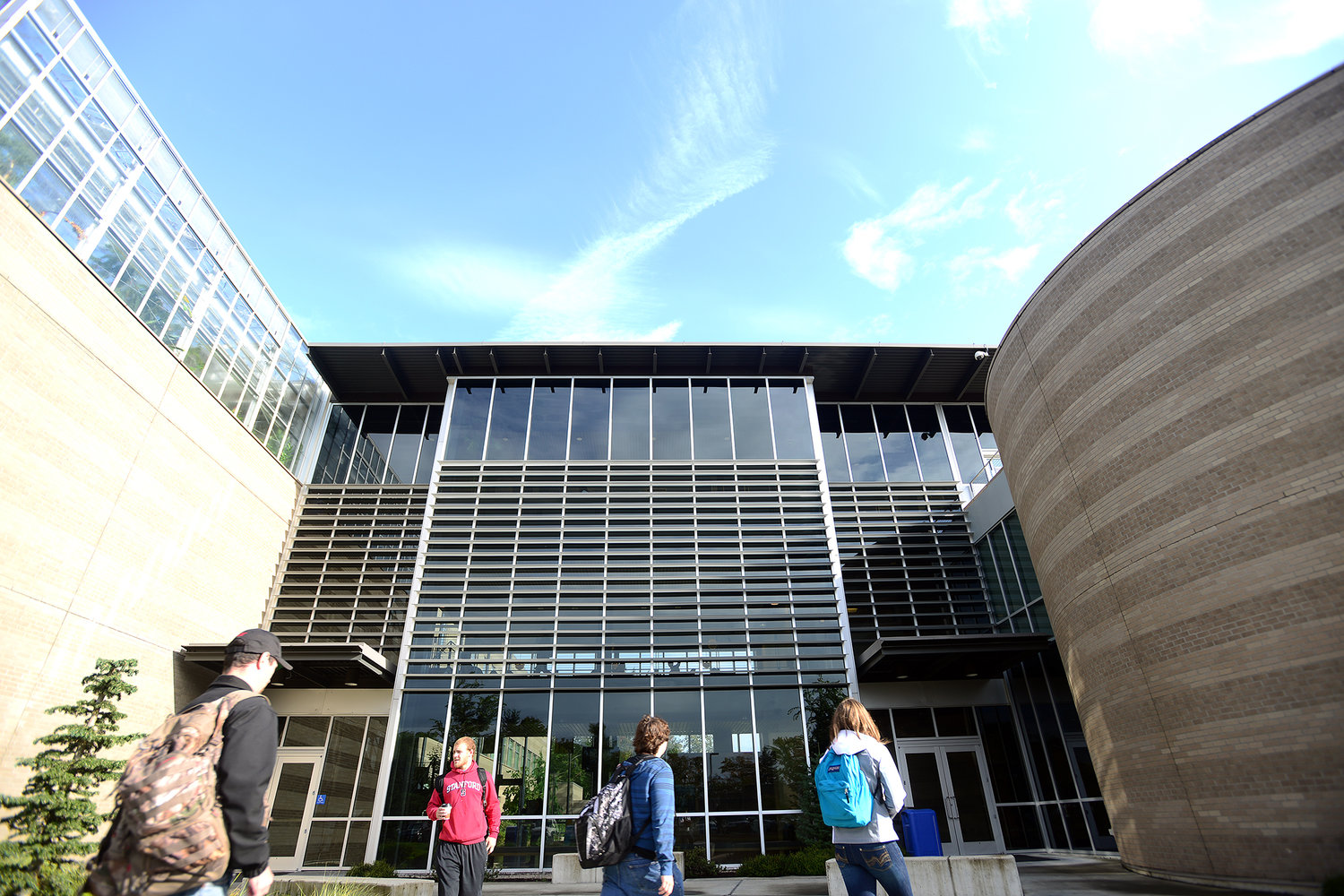 The sun shines briefly on students walking in front of the Walton Science Center on the Centralia College campus in September 2013. 
