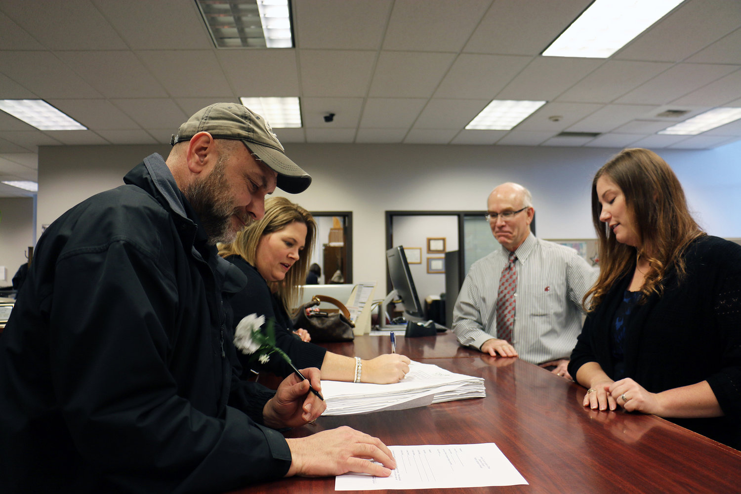 Chamber Board President Todd Chaput and Executive Director Alicia Bull, representatives of the political action committee One Lewis County, turn in over 2,000 signatures to the auditor’s office in early January. 