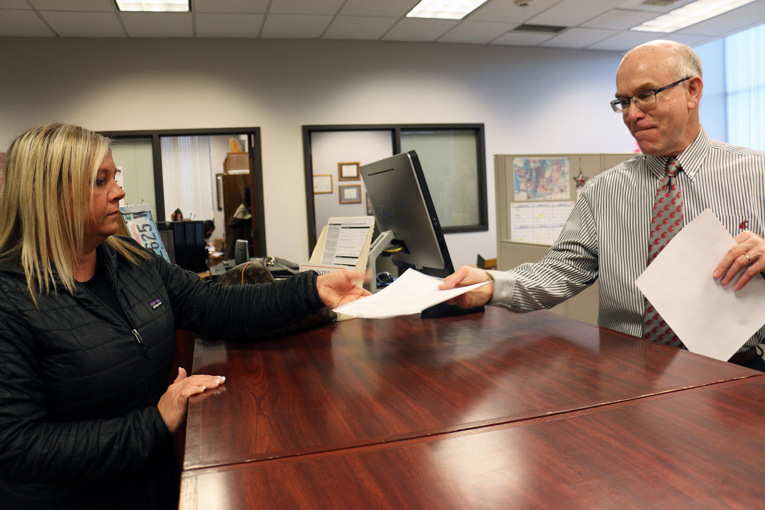 Auditor Larry Groves gives Coralee Taylor her receipt after One Lewis County turned in stacks of petitions. The signatures will be validated by the auditor’s office.