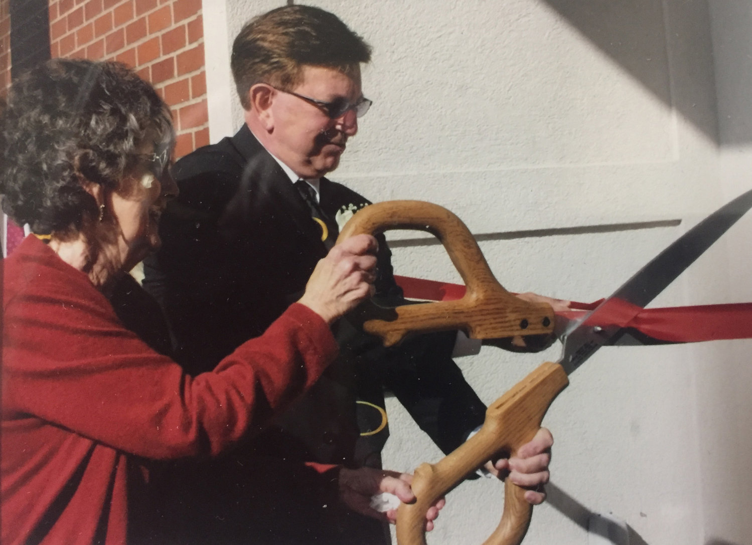 Orin Smith, left, and his mother Vernetta cut a ceremonial ribbon during the opening of the Vernetta Smith Chehalis Timberland Library in this photograph provided by his family. 
