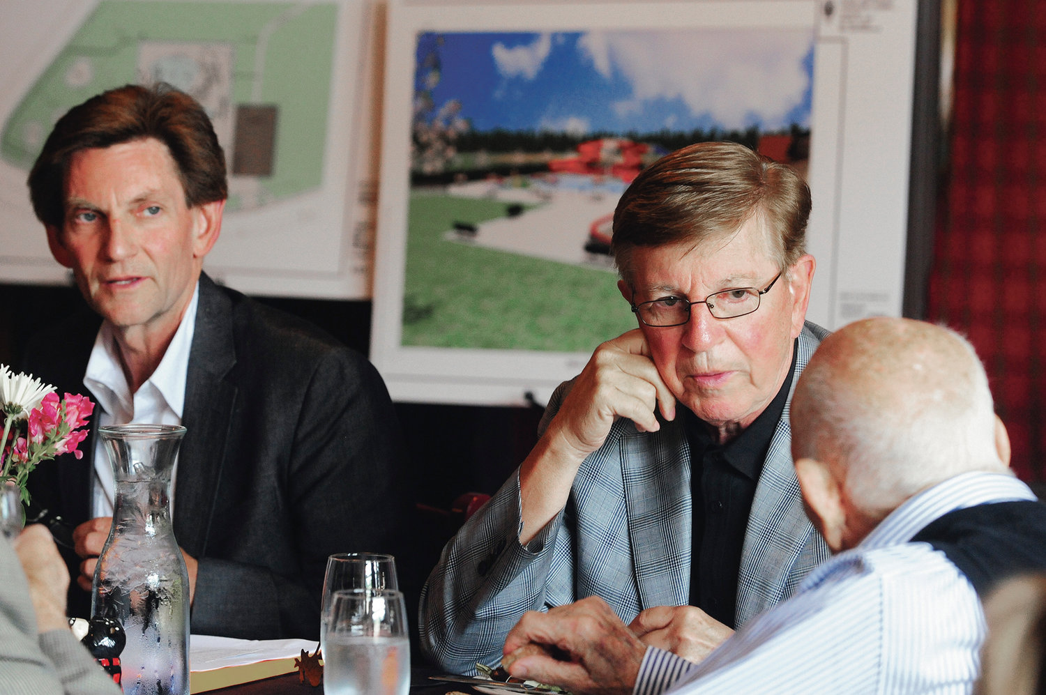 Kevin Smith, left, and his brother, Orin Smith, listen to Gail Shaw speak while at a Chehalis Foundation luncheon at Mackinaw's in Chehalis in this July 2013 file photo.