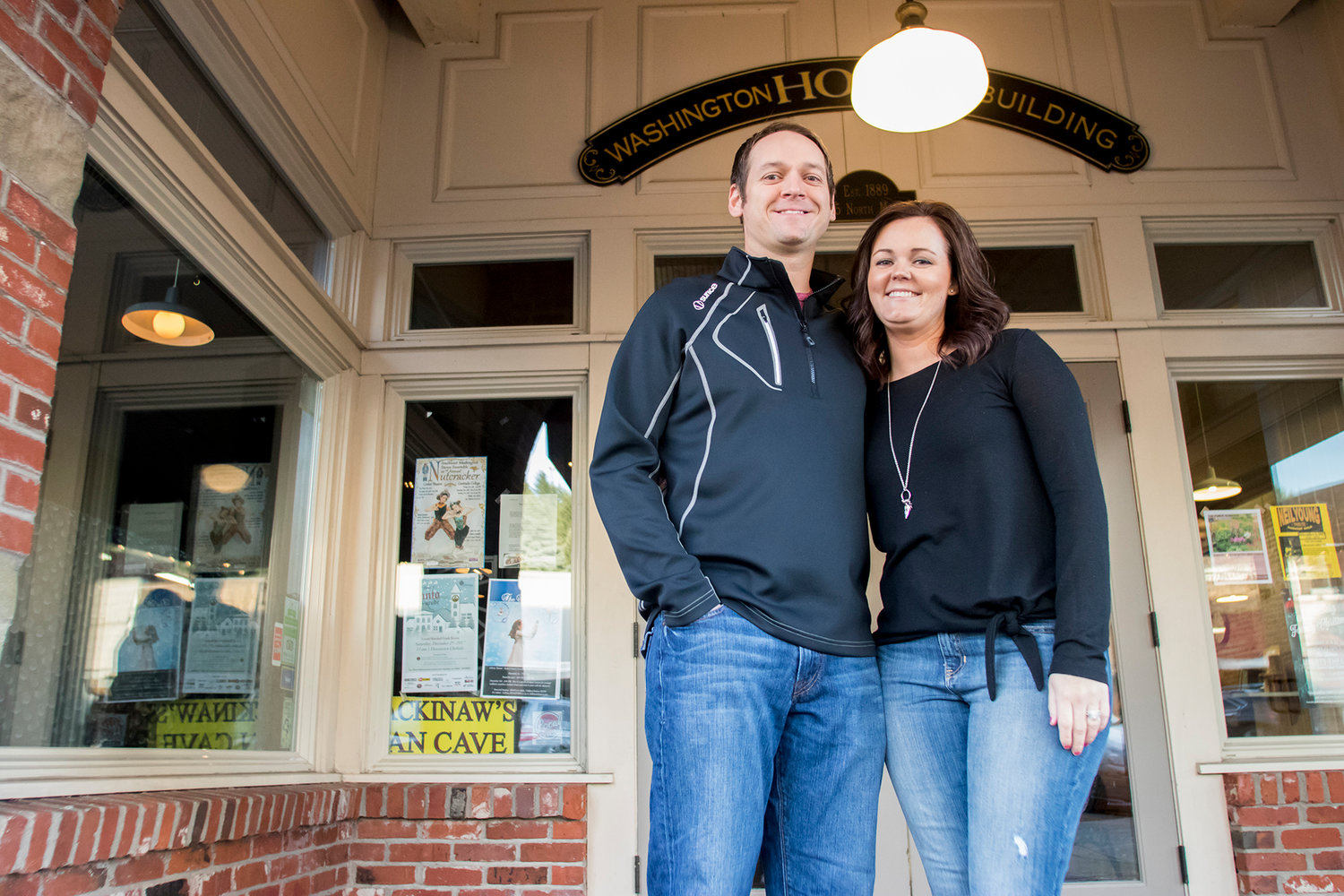 Jason Boettner, left, and his wife Shawna Boettner, right, pose for a photo Wednesday afternoon in downtown Chehalis.