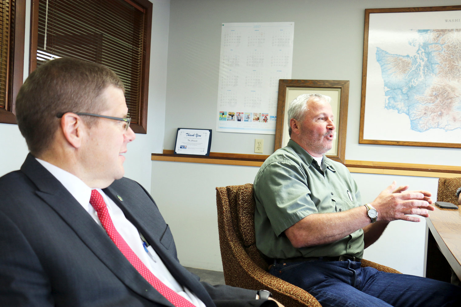 2017 FILE PHOTO — Dan Rich, president of the Centralia Community Foundation, discusses the partnership it has created with the Centralia School District in order to receive a $2 million grant from TransAlta, while Jonathan Meyer, secretary of the foundation and Lewis County prosecutor, looks on.