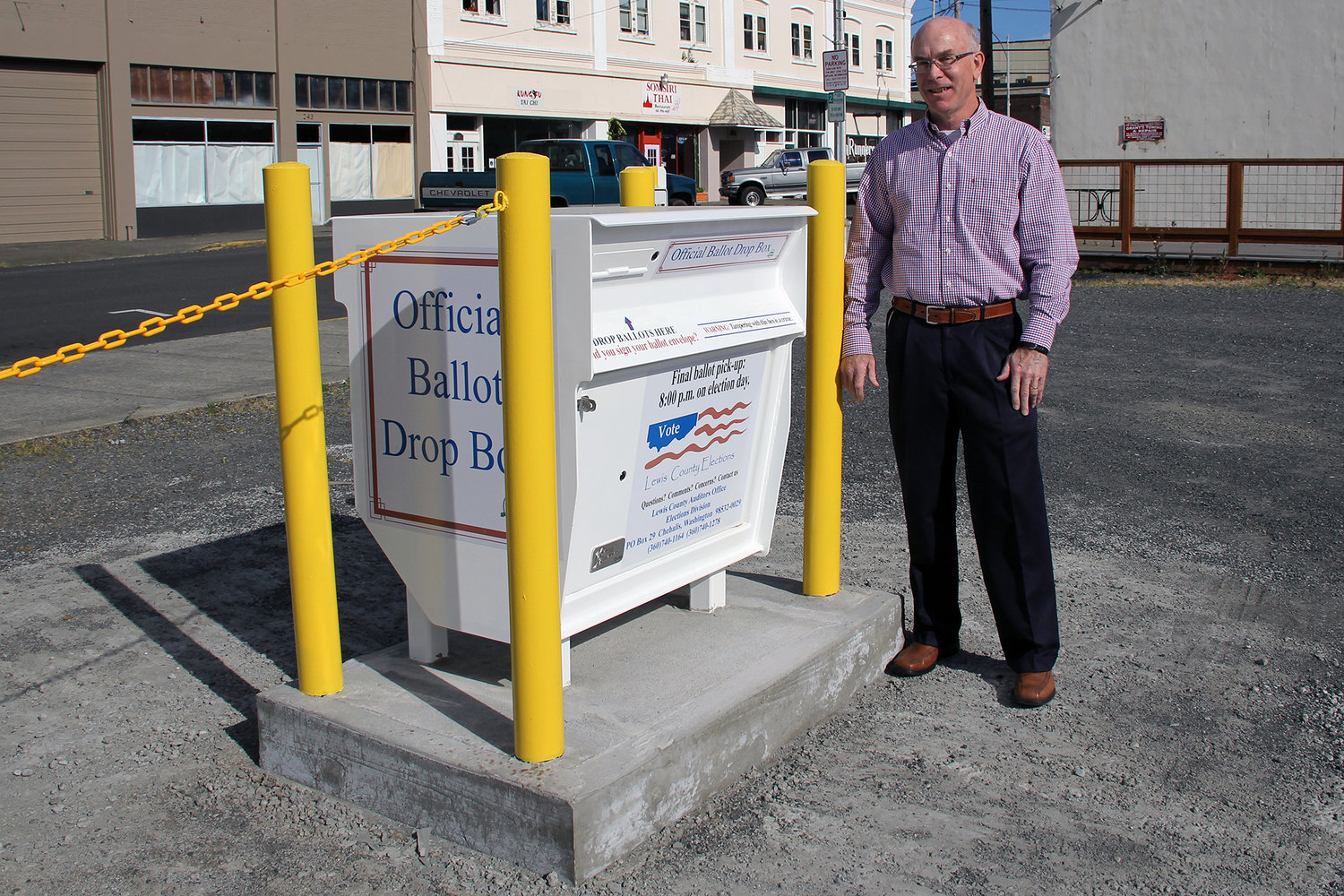 Lewis County Auditor Larry Grove stands by the county's drive up ballot drop box located on Northwest Chehalis Avenue and Northwest Center Street in May 2016. 