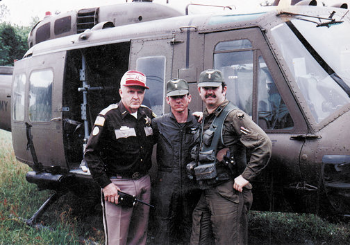 Then-Lewis County Sheriff Bill Wiester poses with the helicopter pilot and observer assigned to him during the Mount St. Helens search and rescue effort, based at what was then the Toledo-Winlock Airport following the May 18, 1980, eruption.