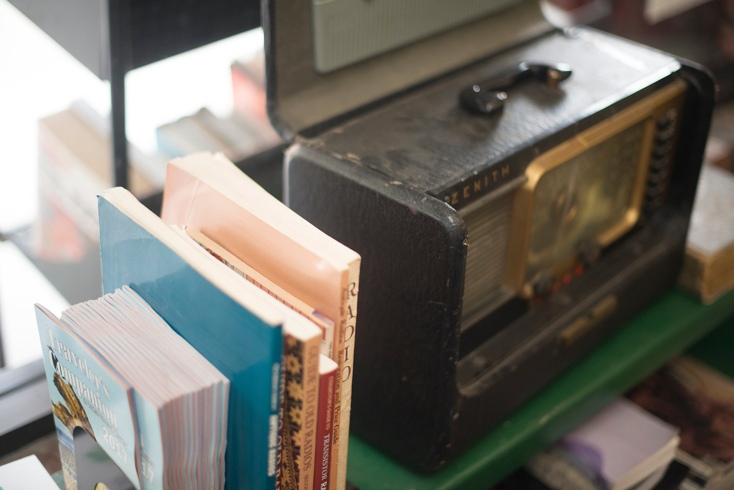A vintage radio sits next to a few books on the subject in Tilikum Books on Tower Avenue. Aside from books, numerous tools and a few knick knacks are also offered for sale.