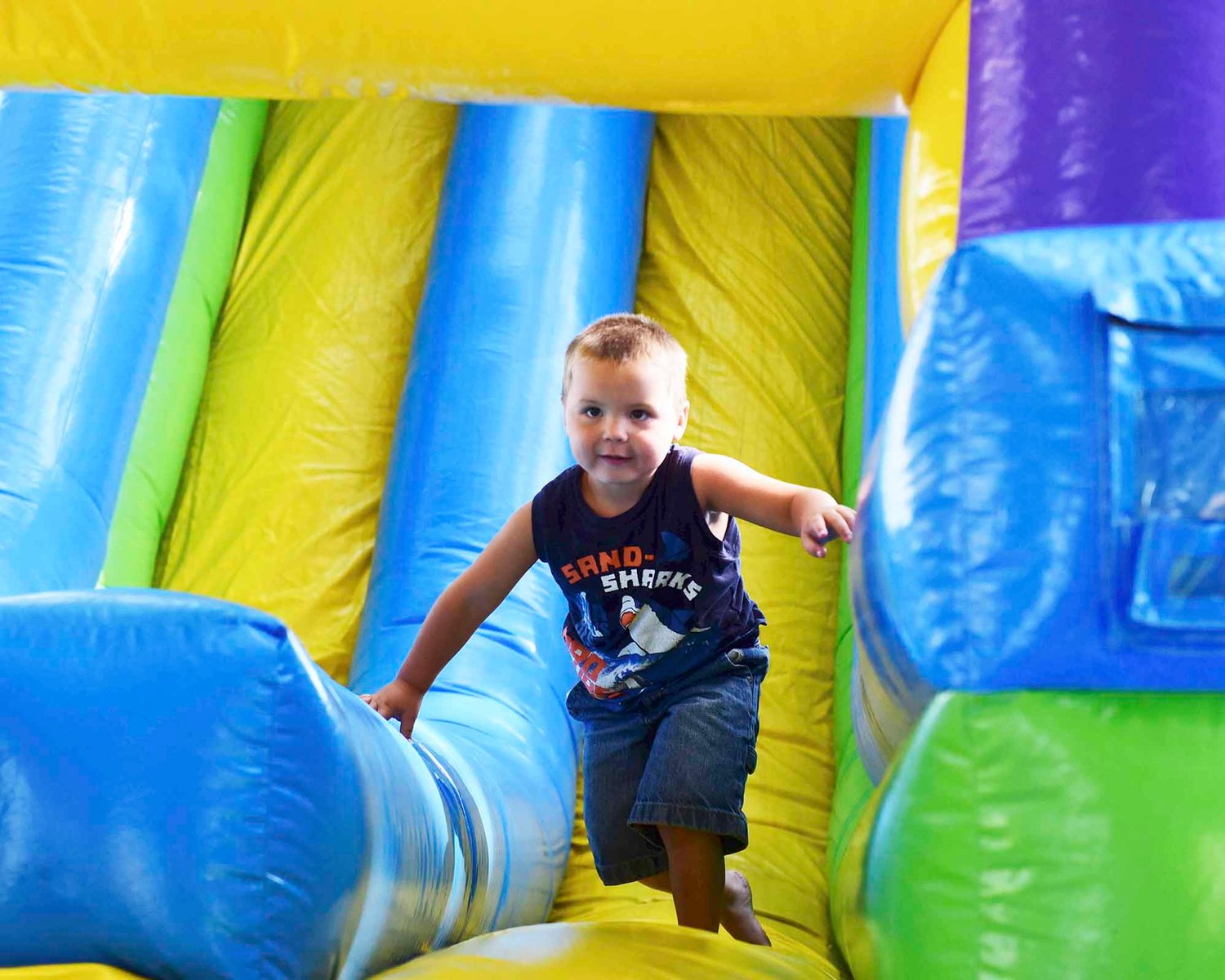 Jayden Mintzer, 4, plays on a bouncy slide at the Thurston-Lewis-Mason Labor Council Labor Day Picnic Monday at George Washington Park.